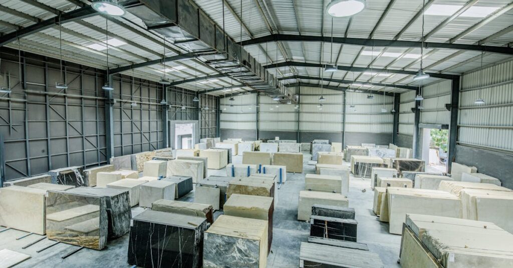 Expansive warehouse filled with large stone slabs for industrial use.
